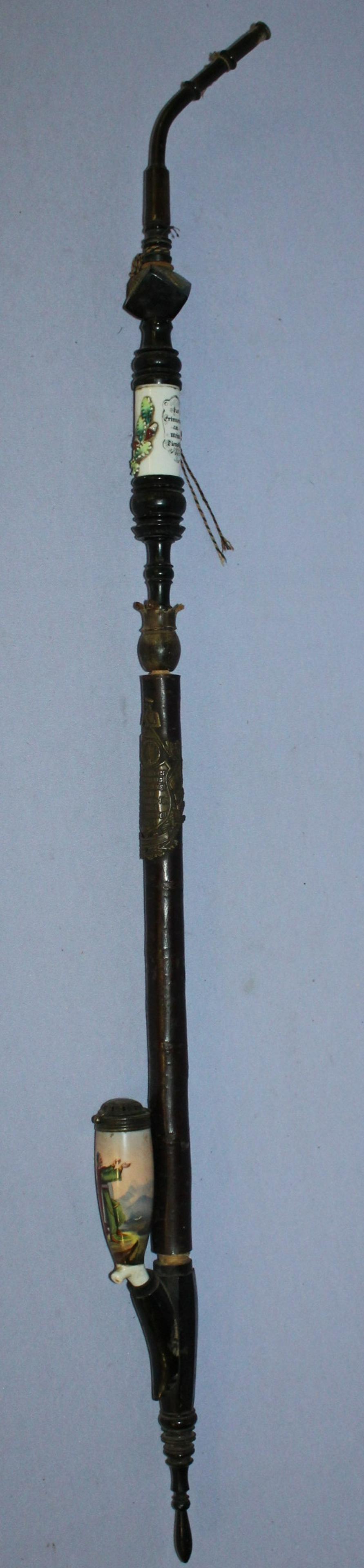 Antique porcelain pipe w/ m.m. stem w/ insert: Antique porcelain pipe w/ m.m. stem w/ insert bowl decor w/ two biblical figures, stem with revolving porcelain insert painted w/ man, brass collar w/ tavern scene and motto, numerals on cube. 38" L