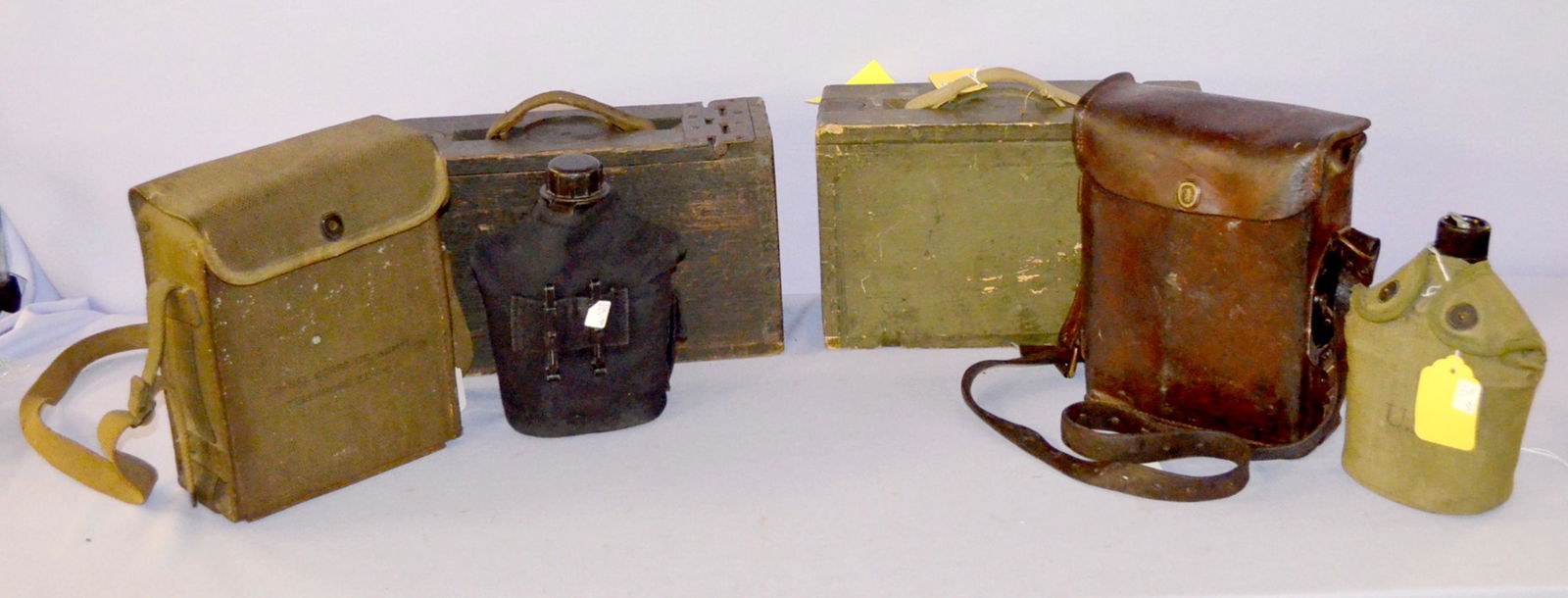 US Military Items; Ammo & Canteens: US Military Items. One is Two WW1 wooden ammo boxes for 30-06 velted ammo. They are 7 3/4 " by 12 5/8" by 4 1/2". Army Signal corps radio in a green pack and another radio in an old leather pack; 1910