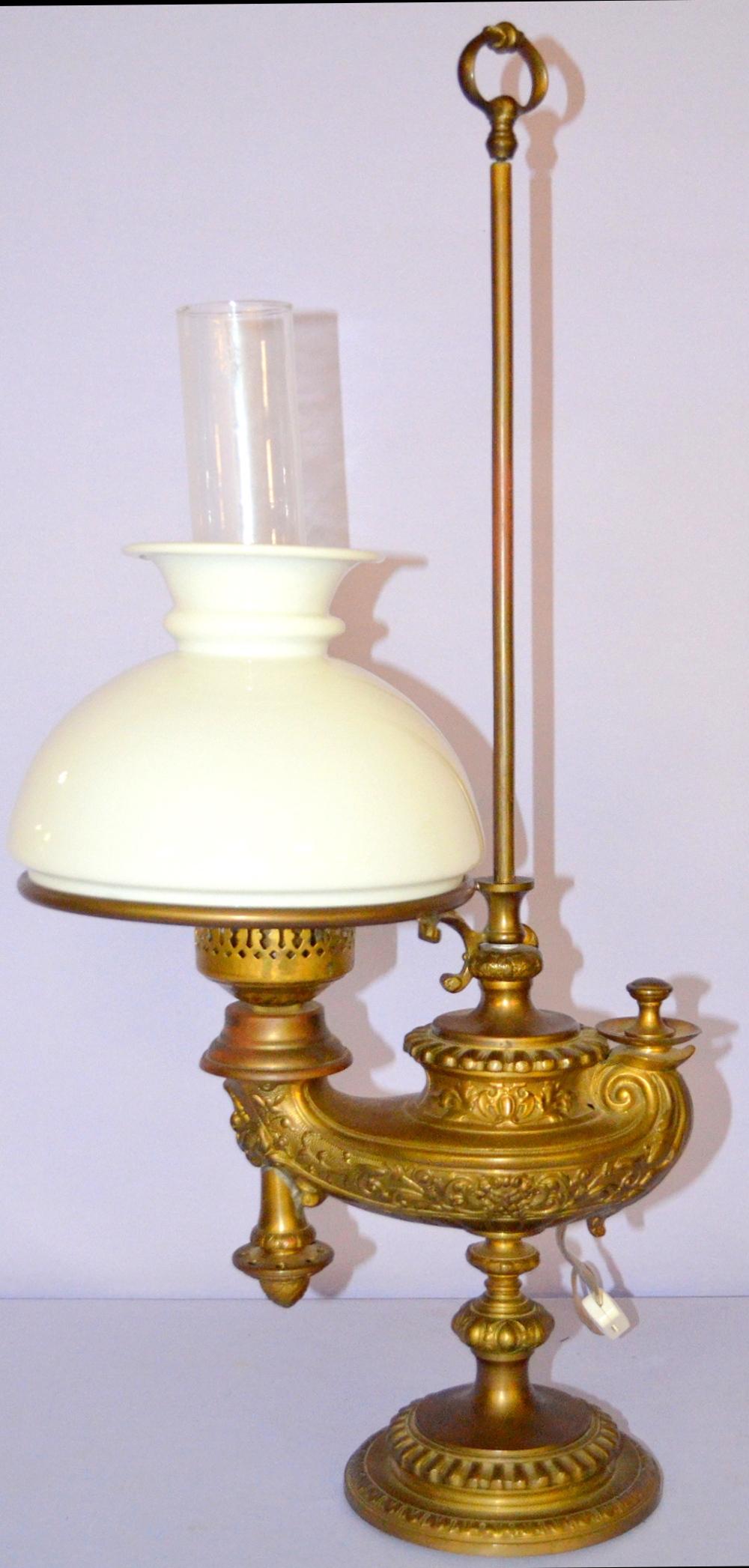 Antique Student Lamp w/ Genie Style Embossed Lamp Base: Antique Student Lamp w/ Genie Style Embossed Lamp Base. Adjustable. White banded shade, chimney, 7 1/2" fitter, electric. 25 1/2" T **This lot is FOB- Freight On Buyer.