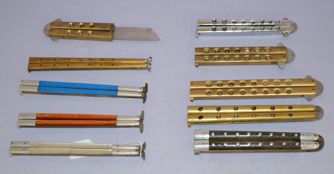 10 butterfly knives: 10 butterfly knives. 4 brass, 1 horn, 1 m.o.p. (one blue, one orange) seven came from the phillipines and 2 from japan. The last is from the parker cultlery co. made of surgical steel. Japan titled "G