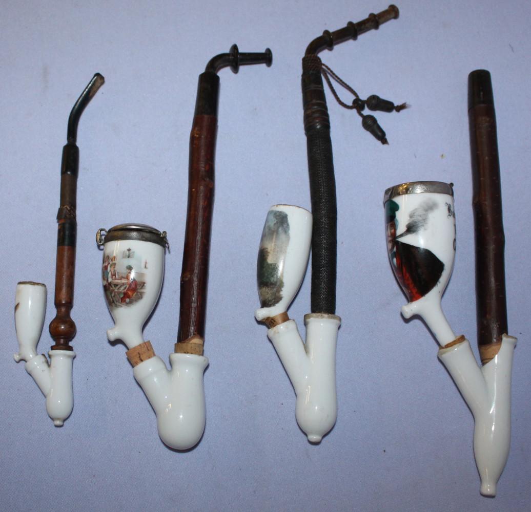 Four antique porcelain pipes w/ stems: Four antique pipes w/ stems. Man smoking w/ adu on rock, rabbit, goats, raven scene. 3 have no caps. 10 3/4" L