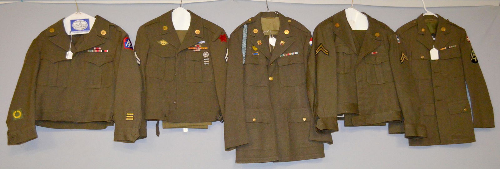 Military clothing: 1- IKE jacket with 5th army ptach and ETO advanced base patches. 2- IKE jacket with pants and these patches - corporal and US far east, also a corps of engineers collar pin. 3- coat with fourragere an