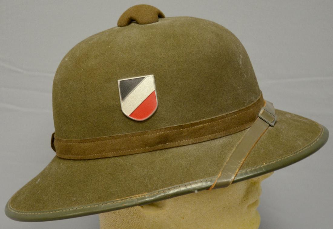 German WWII Africa Korps Tropical Sun Helmet: German WWII Africa Korps Tropical Sun Helmet: there is an Africa Korps badge on the hat and an extra one with it, also a DAK pith helmet badge, a 7 over 57 label is in the lining, showing minor use. 1