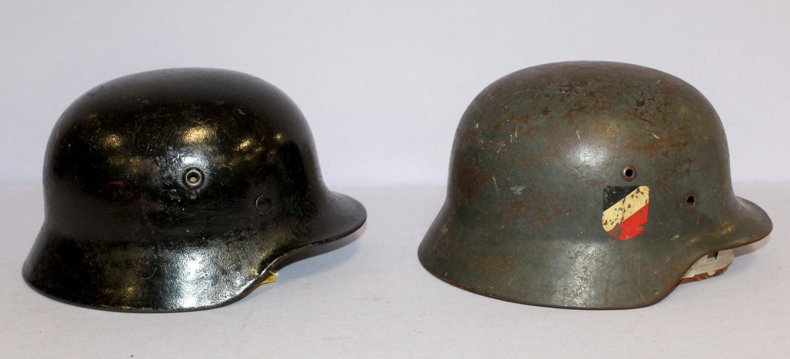 German WWII Helmets: German WWII Helmets: 1) Model 1942 Army, picked up on Bank 7 of the Rhine River in 194, appears to have been repainted, the inside leather shows use but is fully intact, 11 1/8" x 9", 2) Africa Korp s