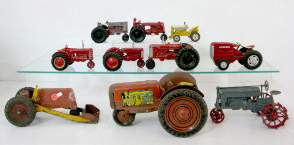 Group of 10 Toy Farm Tractors: Group of 10 Toy Farm Tractors: 1.) Pressed steel with tin litho engine panels. (Fairly rough) 11" 2.) Aluminum tractor with front end loader. (Fairly rough) 11" 3.) Cast iron metal wheel tractor. (Pai