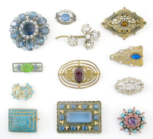 Group of 12 Costume Brooches: Group of 12 Costume Brooches: 1.) Marked Coro with blue and pink rhinestones, lavender cabochon in the center, flip catch. 2.) Unmarked rectangular with large aqua blue glass stone center surrounded b