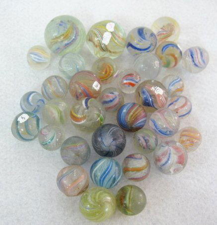 34 Swirl, Latticino & Solid Core Marbles: 34 Swirl, Latticino & Solid Core Marbles: some are excellent, others are kind of rough. None selling as mint condition. Sizes from .60" to 1" All items sell As Is, Where Is, no guarantees of any kind.