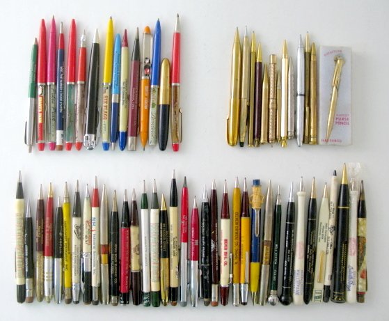 113 Mechanical Pens & Pencils: 113 Mechanical Pens & Pencils: the earliest with slide action is not working; gold colored; 1 has a cigarette lighter under the cap; several with moving scenes in the upper half. Pikes Peak has a larg