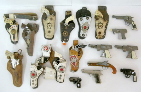 17 Toy Cap Shooters w/Plastic Grips: 17 Toy Cap Shooters w/Plastic Grips: included are 2 Cody Colt; Fanner 50; 2 Pony Boy; 2 Cowhand; Texan; 2 Western in a black and white jeweled leather belt with holsters; and more. Some of the previou