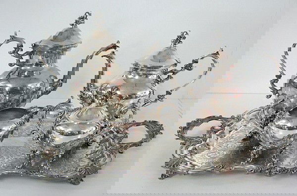 Silverplate Tea & Coffee Service: Silverplate Tea & Coffee Service: silver on copper coffee pot is 11 1/2" tall; a teapot 9 3/4"; covered sugar 6 1/4"; creamer 5 1/2". Makers marks not identified. A non matching tray with handles is w