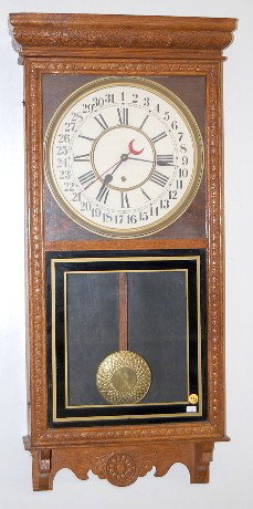 Sessions Regulator "E" Calendar Clock: Sessions Regulator "E" Calendar Clock: 8 day time only movement with a 12" calendar dial. In an oak case with pressed designs. (The dial is new.) 38 1/2" long and running at this time All items sell A