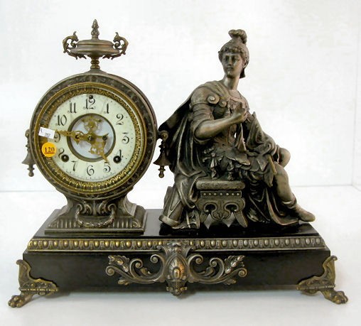 Ansonia "Victory" Statue Clock: Ansonia "Victory" Statue Clock: 8 day time with half hour gong strike and a 5 1/2" dial with visible escapement. (No key. The outer dial is bad. The horn's tip is missing. The metal finish shows wear.