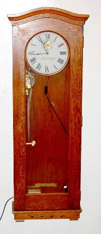 Standard Electric Time Company Wall Clock: Standard Electric Time Company Wall Clock: solid oak case with a 12" dial. Recording instrument and paper tapes intact inside. There are small boxes inside containing paper tape. The boxes are labels