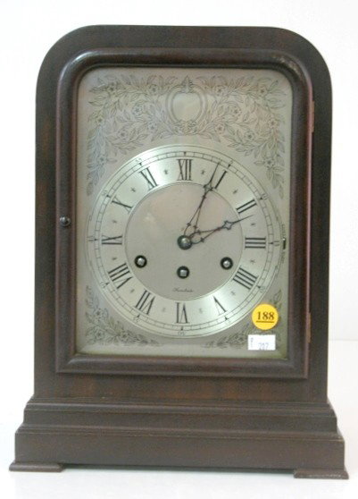 Herschedes Mahogany Chime Clock: Herschedes Mahogany Chime Clock: serial no. 15828 movement with balance wheel and 5 rods for strike. The 5 1/2" dial has floral designs around it. In a mahogany veneer case. With key. (The time of str