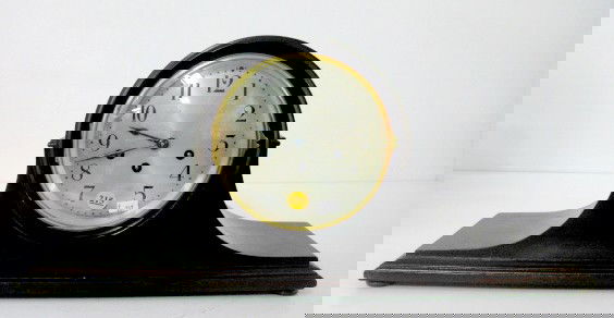 Seth Thomas Tambour Chime Clock: Seth Thomas Tambour Chime Clock: strikes every quarter hour on 5 straight rods, with a 6 1/2" silvered dial in a mahogany case. With key. (The dial has slight scuff marks.) 10 1/4" x 22 5/8" and runni