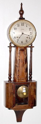 Ingraham "Nile" Banjo Clock: Ingraham "Nile" Banjo Clock: 8 day time with half hour gong strike and a silvered 8" dial. In a mahogany case. With key. (The dial has scuff marks. The case has no finish.) 39" long and running at thi