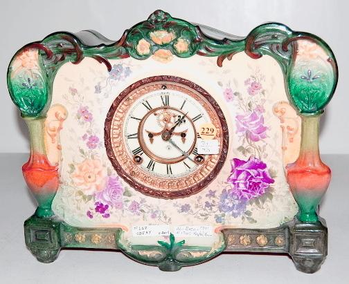 Ansonia Royal Bonn "La Roca" China Clock: Ansonia Royal Bonn "La Roca" China Clock: 8 day time with half hour gong strike and a 4 1/2" dial with visible escapement. In a well marked floral decorated, multicolor case. (Running, but the strike 