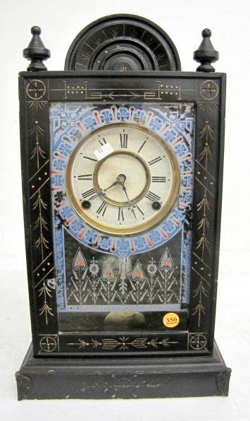 Ebonized Wood Kitchen Clock: Ebonized Wood Kitchen Clock: 8 day time with bell strike and original 5" dial. In an ebonized wood case with impressed and gold painted designs and original glass. With 2 keys. (the dial has wear and 