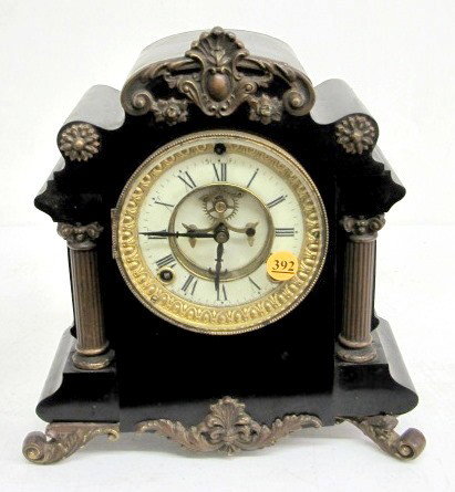 Ansonia Munich Enameled Iron Mantle Clock: Ansonia Munich Enameled Iron Mantle Clock: black enameled iron case with a 5" dial and visible escapement. 8 day time with half hour gong strike. (The strike is slow and time of strike is reversed. Th