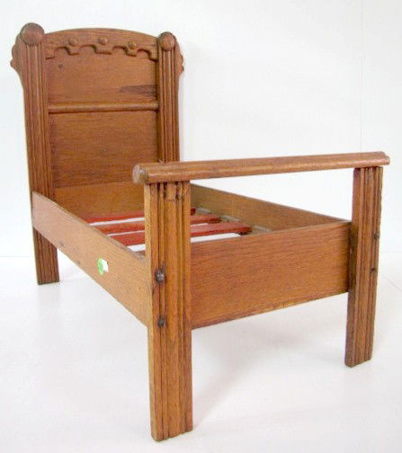 Victorian Oak Doll Bed: Victorian Oak Doll Bed: high headboard with wooden slats. (In as played with condition.) 19" x 21" x 14" All items sell As Is, Where Is, no guarantees of any kind. We accept Mastercard & Visa, no payp