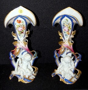 Pair of Old Paris Decorated Cherub Vases: Pair of Old Paris Decorated Cherub Vases: floral, gold and cobalt with Parian type figural cherubs. (1 as is, broken cane and foot.) 12 1/4" All items sell As Is, Where Is, no guarantees of any kind. 