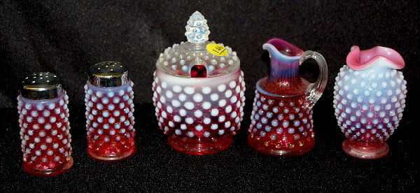 5 Fenton & Cranberry Opalescent Hobnail Items: 5 Fenton & Cranberry Opalescent Hobnail Items: 1.) Covered mustard jar with white opal. hobnail lid. 2.) Miniature cruet. 3.) Pair of salt and peppers, Fenton paper label. 4.) Miniature vase. No condi