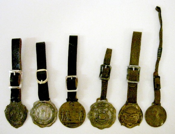 Group of 6 Watch Fobs w/Leather Straps: Group of 6 Watch Fobs w/Leather Straps: 1.) Pressed brass with bi-plane. 2.) Brass General Lafayette 1757-1834, made by Bastian Bros. 3.) Bronze Jackson Tennessee Centennial 1829-1929. 4.) Plated meta