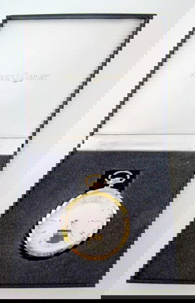 Reuge Musical Pocket Watch in Box: Reuge Musical Pocket Watch in Box: these little gems with visible miniature music boxes are made in Sainte Croix, Switzerland. Polished brass case with a 2 1/4" silvered dial. The case back opens to f