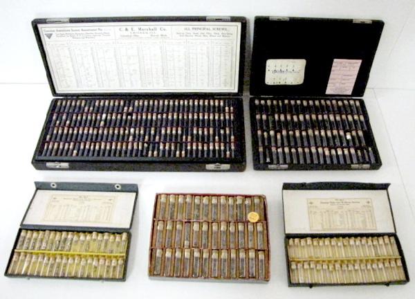 5 Boxes of Vintage Watch Parts: 5 Boxes of Vintage Watch Parts: 1.) Marco watch screws in glass vials with cork stoppers. Chart included. The box has 288 glass vials. 16 1/2" x 6 3/4" 2.) E.C. Marshall Co. watch hands. 81 cork stopp