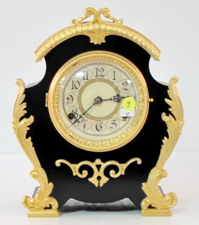 New Haven Enameled Iron Mantle Clock: New Haven Enameled Iron Mantle Clock: 8 day time with gong strike and original 5 1/2" dial. The case has applied floral decoration. (The case looks totally redone. There is no pendulum so movement has