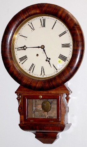 Ansonia Drop Extra Hanging Clock: Ansonia Drop Extra Hanging Clock: 8 day time only spring wound movement with a 12" dial. In a rosewood veneered case. A partial label is inside. With key. 26" and running at this time All items sell A