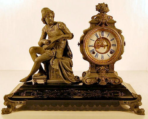 Ansonia Troubadour Figural Clock: Ansonia Troubadour Figural Clock: 8 day time with half hour gong strike. The dial is 5 1/2" and has visible escapement. (The dial has a flaw at the 11. The black enamel on the base is worn on some cor