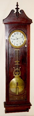 Walnut Gilbert Wall Regulator: Walnut Gilbert Wall Regulator: weight driven time only movement with dead beat escapement. The movement is that of a No.20 regulator. The 12" dial looks like a replacement. A nice lyre pendulum is wit