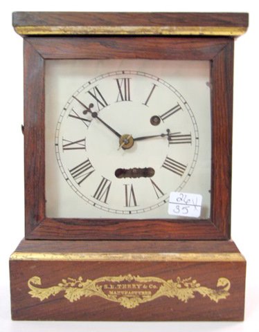 Rare S.B. Terry Miniature Cottage Clock: Rare S.B. Terry Miniature Cottage Clock: time only spring wound movement with torsion bar and verge escapement, with dumb bell pendulum. The case is rosewood veneer. The original gilt maker's name and