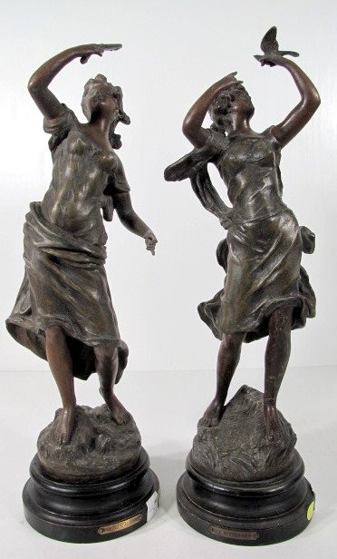 2 White Metal Clock Statues by Rousseau: 2 White Metal Clock Statues by Rousseau: 1.) Le Messager, lady with bird on hand. (Patina rough) 20" 2.) Premier Miroir, lady looking in mirror; (Hole in side; patina rough.) 19 1/2" All items sell As