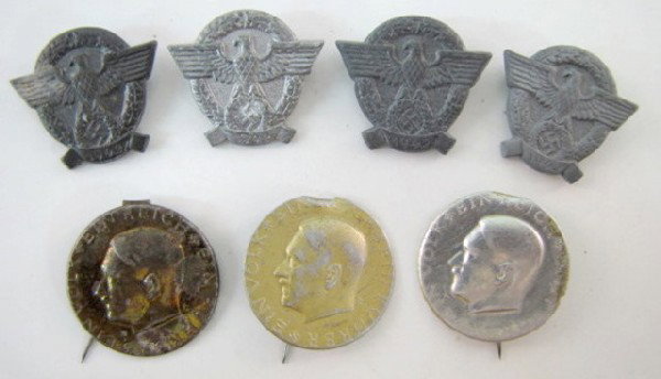 Group of 7 Tinnies of the 3rd Reich: Group of 7 Tinnies of the 3rd Reich: with safety pin style clips. 1.) 3 thin stamped metal in 3 colors with Ein Volk Ein Reich Ein Fuhrer. 2.) 4- 1942 eagle and wreath, cast aluminum; 1 marked H4, 1- 