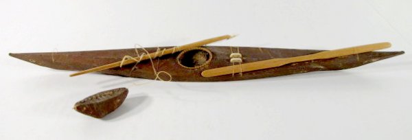 Hide & Ivory (or Bone) Eskimo Toy Kayak: Hide & Ivory (or Bone) Eskimo Toy Kayak: hide covered with a paddle and harpoon; ivory or bone harpoon head and ivory or bone on boat. (Some scuffs and scrapes, but overall good condition.) 26" All it