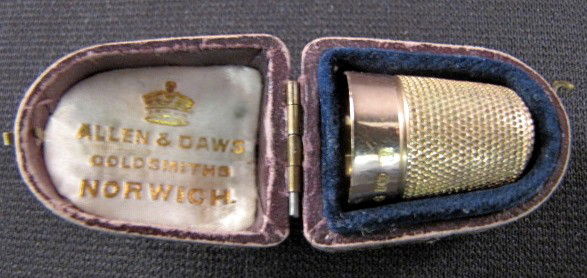 10 Karat Gold English Thimble in Case: 10 Karat Gold English Thimble in Case: the size 7 thimble has Chester England hallmarks, maker's C.H. in a rectangle, Chestertown mark, 9, .375 and date letter O. The date letter matches that for 1739