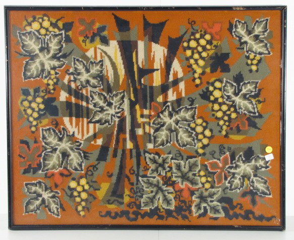 Framed Needlepoint Panel w/Golden Grape Clusters: Framed Needlepoint Panel w/Golden Grape Clusters: with multicolored leaves spread out on an orange background. Some geometric designs are included. In a simple wooden frame with glass surface. 25" x 3
