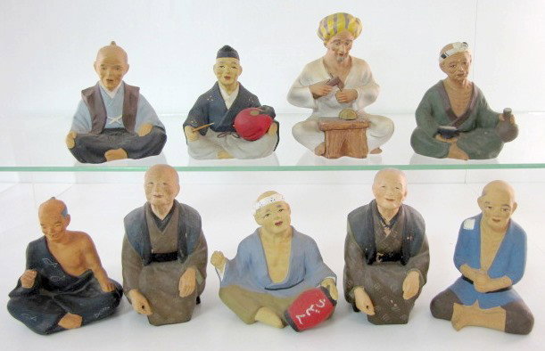 9 Japanese Hakata Clay Figures: 9 Japanese Hakata Clay Figures: one looks more Arabian than Oriental, he sits cross-legged, has a small wooden stool with a vase shape on it, he holds a tool of some sort and is the largest at 6 1/4".