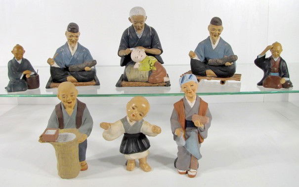 8 Japanese Hakata Clay Figures: 8 Japanese Hakata Clay Figures: 1.) Kneeling woman grooming a child's hair, 6 1/4". 2.) 2 seated men with doll like figures; sitting on woven mats. 5" 3.) Standing man with basket of grain, 6 1/2". 4.