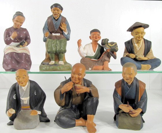 7 Japanese Hakata Clay Figures: 7 Japanese Hakata Clay Figures: 1.) Standing old man with a hoe, 7 3/4". 2.) Kneeling man with cup, 5 3/4". 3.) Seated man with chopsticks and bowl of rice, 6". (His hat has been reattached to his hea