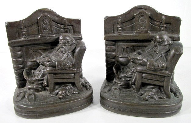 Pair Metal Clad Fireplace Bookends by C.S. Allen: Pair Metal Clad Fireplace Bookends by C.S. Allen: a portly gentleman with pipe and books sits by a fireplace with hanging kettle. A dog is under the chair. On the mantel is a pair of candlesticks and 