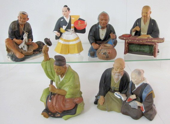 6 Large Japanese Hakata Clay Figures: 6 Large Japanese Hakata Clay Figures: 1.) Seated woman with crab basket, she sits on a wooden platform, 8". 2.) Warrior like figure with Lida's label, 9 1/2". 3.) Seated man with stringer of fish and 