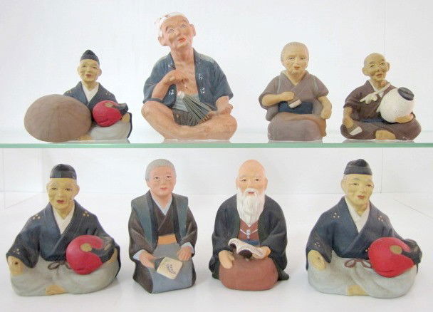 8 Small Japanese Hakata Clay Figures: 8 Small Japanese Hakata Clay Figures: all are seated men and women with a variety of objects in their hands, bushes, fans, books and unidentified. (Hats are missing from 2.) 4 1/2"-6 1/2" All items se