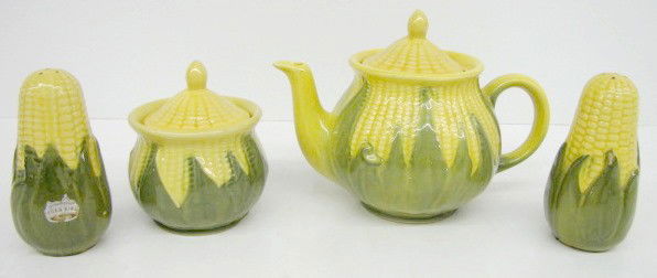 4 Pieces of Shawnee Pottery Corn Kitchenware: 4 Pieces of Shawnee Pottery Corn Kitchenware: 1.) Teapot, marked on bottom Shawnee. 2.) Covered sugar, marked on bottom USA. 3.) Pair of corn shakers. (The 4 hole one has a chip on one side.) Tallest