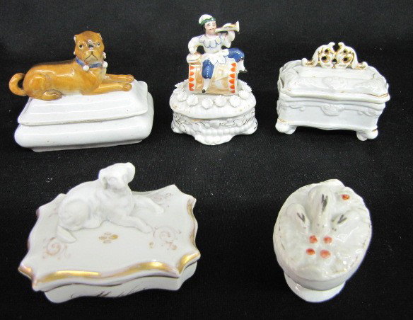 5 Porcelain Figural Covered Ring/Pin Boxes: 5 Porcelain Figural Covered Ring/Pin Boxes: all unmarked. 1.) Boxer type dog on top of a rectangular box; he looks ready to play. 2.) A long haired dog on top of a rectangular box; he is bisque, while