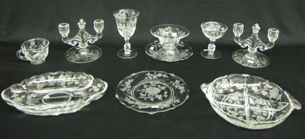 46 Pieces of Heisey Rose Dinnerware: 46 Pieces of Heisey Rose Dinnerware: pair of double candlesticks; 3 section relish; 4 section relish; mayo and under plate; 10 champagnes; 8 stemmed water goblets; 11 cups; 12-8 1/2" plates. No condit