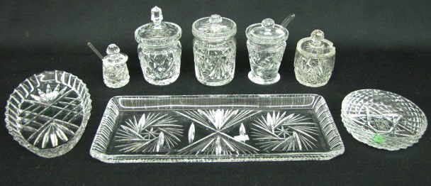 Group of 8 Cut Crystal Trays & Table Jars: 8 Cut Crystal Trays & Table Jars: 1.) Oval tray with Galway Irish Crystal sticker. 2.) Unmarked rectangular tray. 3.) 5 crystal jam and mustard jars, 3 with spoons. 4.) Crystal round bowl. No conditio