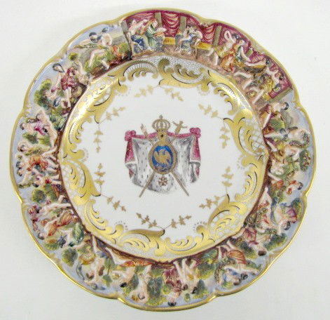 10" Ornate Capodimonte Molded Plate: Marked N Capodimonte Molded Plate: marked with N, crown and "Au Roi de Rome Napler 1811" on the back; center of plate decorated with shield, swords, royal crown and cape; the edge is molded with froli